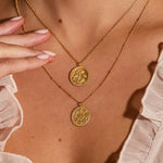 Layered necklaces showcasing the Joyful Beginnings Necklace, with its gold lotus pendant and white topaz, embodying a sense of elegance and spiritual connection, ideal for yoga, manifestation, and talisman wearers.