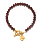 Balanced Beginnings Garnet Lotus Bracelet featuring rich garnet beads and an 18kt gold plate lotus pendant, perfect for those seeking spiritual jewelry for meditation and meaningful manifestation.