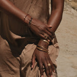 Elegant shot of the Healing Heart Red Onyx Heart Bracelet on a model’s arm, emphasizing its significance in spiritual journeys and its protective qualities under the sun and moon.