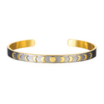 Spiritual Evolution Moon Phase Cuff featuring phases of the moon on a gunmetal background. This stylish spiritual jewelry piece symbolizes nourishment, protection, and the goddess, making it perfect for meditation, manifestation, and yoga practice.