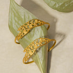Two Expanding Beauty Lotus Cuffs displayed on a leaf backdrop, highlighting their intricate design and symbolic meanings of transformation and renewal, perfect for talismans in spiritual practices.