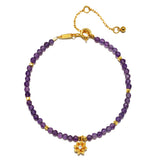 Amethyst Lotus February Birthstone Bracelet featuring faceted round amethyst beads and an 18k gold plated lotus flower pendant, symbolizing spirituality and new beginnings. This piece of spiritual jewelry is perfect for meditation and manifestation, ideal for yoga practitioners seeking a meaningful talisman for protection and peace of mind.