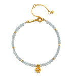 Aquamarine Lotus March Birthstone Bracelet featuring aquamarine beads and an 18kt gold plated lotus flower pendant, symbolizing tranquility and new beginnings, perfect for those seeking spiritual jewelry for meditation and manifestation.
