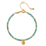 Emerald Lotus May Birthstone Bracelet showcasing a beautiful design with emerald gemstones and an 18kt gold plated lotus flower, perfect for those seeking spiritual jewelry, meditation, and manifestation. This bracelet is an elegant talisman for yoga practitioners, embodying meaning and protection.