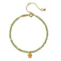 Peridot Lotus August Birthstone Bracelet featuring a delicate gold-plated lotus charm and faceted peridot beads, symbolizing new beginnings and harmony. This spiritual jewelry serves as a meaningful talisman for meditation and manifestation, perfect for yoga enthusiasts and those seeking protection. Related to zodiac traits, this bracelet's design embodies the essence of the sun and moon.