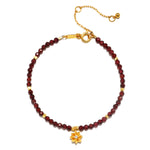 Red Garnet Lotus January Birthstone Bracelet, a stunning piece of spiritual jewelry featuring red garnet beads, symbolizing grounding and love, adorned with an 18kt gold plated lotus flower. This meditation talisman embodies transformation and renewal, perfect for those interested in zodiac meanings. Ideal for yoga enthusiasts and anyone seeking meaningful manifestation and protection in their life.