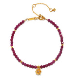 Ruby Lotus July Birthstone Bracelet featuring a stunning arrangement of ruby beads and an 18kt gold plated lotus flower, symbolizing new beginnings and integral for spiritual jewelry, meditation, and manifestation. Perfect for enhancing your yoga practice and protecting your energy.