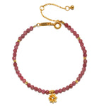 Pink Tourmaline Lotus October Birthstone Bracelet featuring round pink tourmaline beads with an 18kt gold plated lotus flower pendant. This spiritual jewelry piece embodies creativity and inspiration, making it a meaningful talisman for meditation and manifestation. Ideal for yoga enthusiasts and those seeking spiritual protection, this bracelet symbolizes new beginnings and aligns with zodiac energies.