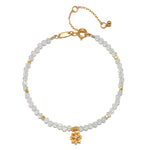 White Topaz Lotus April Birthstone Bracelet featuring a gold lotus flower pendant, perfect for meditation and manifestation, embodying meanings of spiritual jewelry and protection. Ideal for yoga enthusiasts seeking a meaningful talisman.