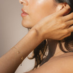 Model wearing the Enchanted Journey Celestial Charm Bracelet, highlights the connection to zodiac energy and meaningful spiritual jewelry, ideal for yoga enthusiasts seeking guidance from the moon and stars.