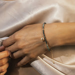 A close-up of the Channeling Wisdom Sapphire Starburst Beaded Bracelet on a hand, highlighting its delicate design. This meaningful piece embodies spiritual energy, protection, and is ideal for yoga practitioners and those seeking inspiration.