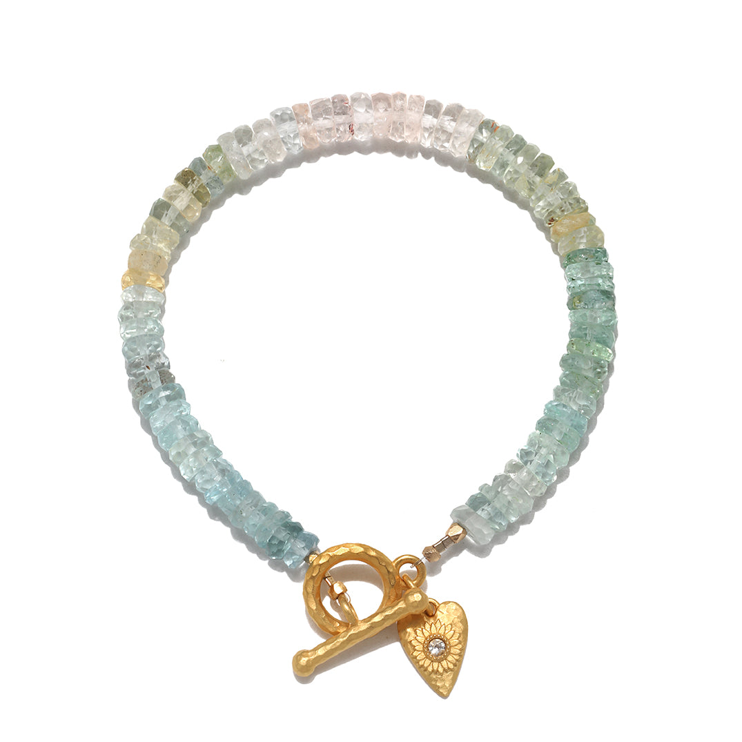 Tranquil Spirit Aquamarine Heart Toggle Bracelet displayed elegantly, showcasing unique aquamarine stones. This piece of spiritual jewelry serves as a meditation talisman, embodying the meaning of protection and peace, perfect for aligning with zodiac energies and enhancing yoga practices.