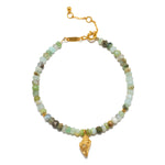 Beaded bracelet with pale green and white faceted stones, gold-tone chain, rectangular connector, and dangling gold shell cha