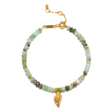 Beaded bracelet with pale green and white faceted stones, gold-tone chain, rectangular connector, and dangling gold shell cha