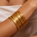 Gold Large Bangle Bracelet Cuff - Something Special displays an elegant arrangement of gold bangles, symbolizing manifestation and meaningful connection, making it an exquisite amulet for meditation and yoga lovers.