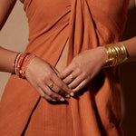 Elegant Small Gold Bangle Bracelet Cuff - Something Special showcasing a model wearing layered spiritual jewelry, perfect for meditation gifts and yoga practice, with a meaningful and symbolic design representing manifestation and protection.