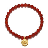 Sacral Chakra Carnelian Stretch Bracelet featuring 6mm faceted carnelian stones and a 12mm gold plated charm, perfect for spiritual jewelry, meditation gifts, and yoga practices for manifestation and protection.