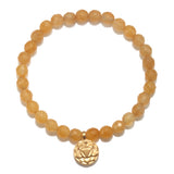 Solar Plexus Chakra Yellow Jade Stretch Bracelet showcasing jade beads and a gold charm, perfect for spiritual jewelry and meditation. This talisman symbolizes empowerment and is ideal for yoga practices, manifestation, and personal meaning.
