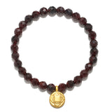 Root Chakra Garnet Stretch Bracelet featuring beautifully faceted garnet beads and an 18kt gold plated charm, symbolizing grounding and security. This piece of spiritual jewelry is perfect for meditation gifts, enhancing your yoga practice and aiding in manifestation. Its meaningful design makes it a protective amulet, connecting to sacred energies and zodiac influences.