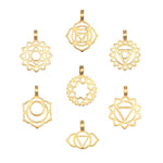 Seven gold-toned metal charms with geometric chakra symbols and lotus petal designs arranged in a circular pattern.