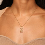 Woman wearing the Goddess Durga Charm on a delicate gold necklace, showcasing its significance in spiritual jewelry and its connection to protection and meaningful meditation practices. A perfect talisman for those embracing their spiritual journey.