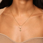 Close-up of a necklace featuring the Ganesha Hindu God Charm styled with a gold circle pendant, representing spiritual connection and personal growth. This elegant piece of spiritual jewelry is a powerful talisman for meditation and protection, perfect for yoga enthusiasts and anyone seeking meaningful manifestation.