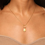 Blooming Lotus Charm worn as a necklace, showcasing its elegance and significance. This piece of spiritual jewelry embodies protection and meaningful connections, perfect for those who practice yoga and seek deeper meanings.