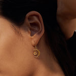 Close-up of the Spirit in Transformation Lotus Moon Earrings, highlighting the intricate lotus and crescent moon details. This spiritual jewelry piece serves as a powerful charm for yoga practitioners, promoting meditation and intention-setting while embodying the essence of protection and meaningful manifestation.