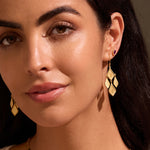 A close-up portrait of a woman confidently wearing the Adorned with Light Chandelier Earrings. This piece of spiritual jewelry embodies elegance and purpose, making it a meaningful accessory for those exploring meditation, protection, and the symbolic connections to the zodiac.