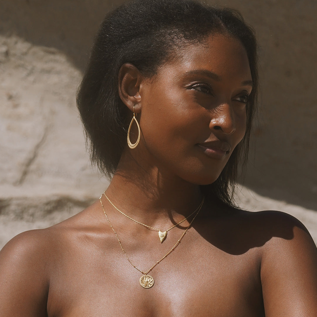 Close-up of a model wearing the Graceful Beauty Dot Teardrop Earrings, combining style and spirituality, making them perfect for yoga, connecting with zodiac energies, and enhancing your spiritual journey.