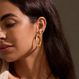 A model wearing Pure Heart Earrings alongside other pieces, highlighting their versatility in an earstack. These earrings serve as a meaningful talisman for protection and spiritual connection, ideal for those embracing zodiac energies and meditation.
