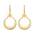 Stellar Sisterhood Moonstone Hoops featuring hammered 18kt gold plate and moonstone accents, embodying spiritual jewelry for those seeking protection and guidance in their meditation and yoga practices. These meaningful earrings symbolize the connection between sun and moon, enhancing manifestation and zodiac energy.