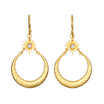 Stellar Sisterhood Moonstone Hoops featuring hammered 18kt gold plate and moonstone accents, embodying spiritual jewelry for those seeking protection and guidance in their meditation and yoga practices. These meaningful earrings symbolize the connection between sun and moon, enhancing manifestation and zodiac energy.