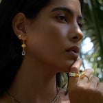 A woman showcasing True Self Green Amethyst Earrings, teardrop-shaped green amethyst paired with rose quartz, radiating beauty and spiritual energy. Perfect for meditation and manifestation, these meaningful earrings symbolize self-love and emotional balance. Ideal for yoga enthusiasts and those seeking protection, they make a stunning addition to any jewelry collection.