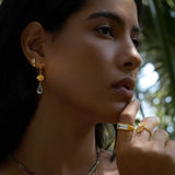 A woman showcasing True Self Green Amethyst Earrings, teardrop-shaped green amethyst paired with rose quartz, radiating beauty and spiritual energy. Perfect for meditation and manifestation, these meaningful earrings symbolize self-love and emotional balance. Ideal for yoga enthusiasts and those seeking protection, they make a stunning addition to any jewelry collection.