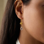 Model wearing Spiritual Journey Lotus Crystal Earrings, beautifully designed with gold lotus flowers and crystal drops, embodying spiritual protection and serving as a magical talisman for mindfulness and meditation.