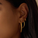 Textured Gold Mini Hoop Earrings displayed alongside larger hoop sizes, emphasizing their versatility in personal ear stacks. These earrings embody the meaning of spiritual jewelry, suitable for those who appreciate talismans and zodiac themes.