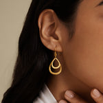 Close-up of a model wearing Seek the Light Earrings, showcasing the elegant hammered gold plating and their connection to spiritual practices, making them a beautiful talisman for meditation, yoga, and spiritual journeys.