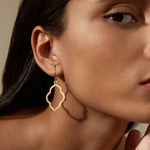 Close-up of a model wearing Full Bloom Lotus Petal Earrings, showcasing their elegant silhouette. This spiritual jewelry piece embodies the meaning of transformation and renewal, ideal for those seeking meaningful accessories for meditation and self-expression.