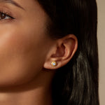 A model wearing Insightful Spirit White Topaz Stud Earrings, highlighting the elegant round white topaz that brings clarity and intention, ideal for individuals interested in spiritual, zodiac, and yoga themes.