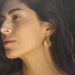 A close-up of a woman wearing Guiding Star Celestial White Topaz Stud Earrings, showcasing the beautiful crescent moon and star design, perfect for spiritual jewelry, meditation, talismans, and zodiac enthusiasts seeking protection and meaning in their lives.