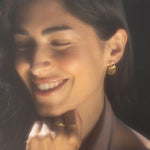 A woman showcases Scattering Stardust Moonstone Fringe Stud Drop Earrings, embodying spiritual jewelry that resonates with meditation and serves as a talisman. The moonstone elements reflect themes of zodiac and spiritual protection, perfect for yoga and those seeking deeper meaning in their manifestations.