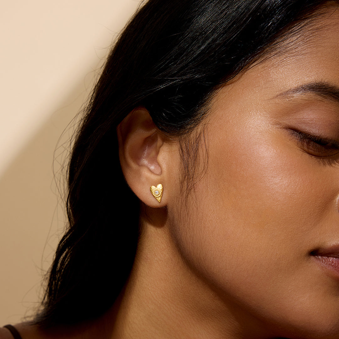 A model wearing the Sacred Connection Heart Lotus Stud Earrings, showcasing their stunning design and spiritual significance. These earrings represent love and clarity, making them perfect for meaningful connections and enhancing manifestation during meditation and yoga, embracing the essence of spiritual jewelry.