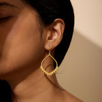 Close-up of Open to Receive Lotus Petal Hoop Earrings worn by a model, showcasing their beauty as spiritual jewelry. These earrings serve as a talisman for meditation and manifestation, radiating meaning and protection, perfect for those who embrace the sun and moon.