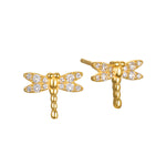 Pair of gold-tone dragonfly stud earrings with white crystal embellishments on wings and body.