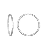Textured Sterling Silver Large Hoop Earrings, featuring a striking design that embodies spiritual jewelry aesthetics. Perfect for meditation and reflecting personal meaning, these hoops make a statement in any ear stack. Ideal for those who appreciate the symbolic aspects of spiritual and protective adornments like talismans, reminiscent of the sun and moon's energy in yoga and manifestation.