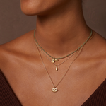 Close-up of the Guiding Hand Mini Hamsa Necklace worn with additional delicate necklaces, embodying themes of spiritual jewelry and charm, perfect for yoga and mediation enthusiasts seeking protection and meaning.