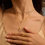 Close-up of the Inspired Beginnings Labradorite Petal Beaded Necklace layered with additional delicate chains, illustrating the beauty of talismans that inspire spiritual growth and meditation. This piece is perfect for yoga practitioners and those seeking to enhance their connection to the sun and moon.