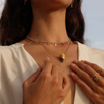 A close-up of the Guiding Spirit Labradorite and White Topaz Lotus Locket Necklace worn by a model, embodying the essence of spiritual jewelry that deepens meditation and enhances personal meaning through talismans.