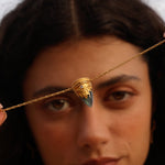 A model showcasing the Guiding Spirit Labradorite and White Topaz Lotus Locket Necklace, symbolizing spiritual purpose and protection while wearing talismans for meaningful experiences and zodiac alignment.
